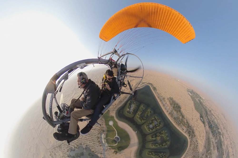 Riders enjoying the thrill of flying over DDCR with Paramotor Adventure Ride in Dubai